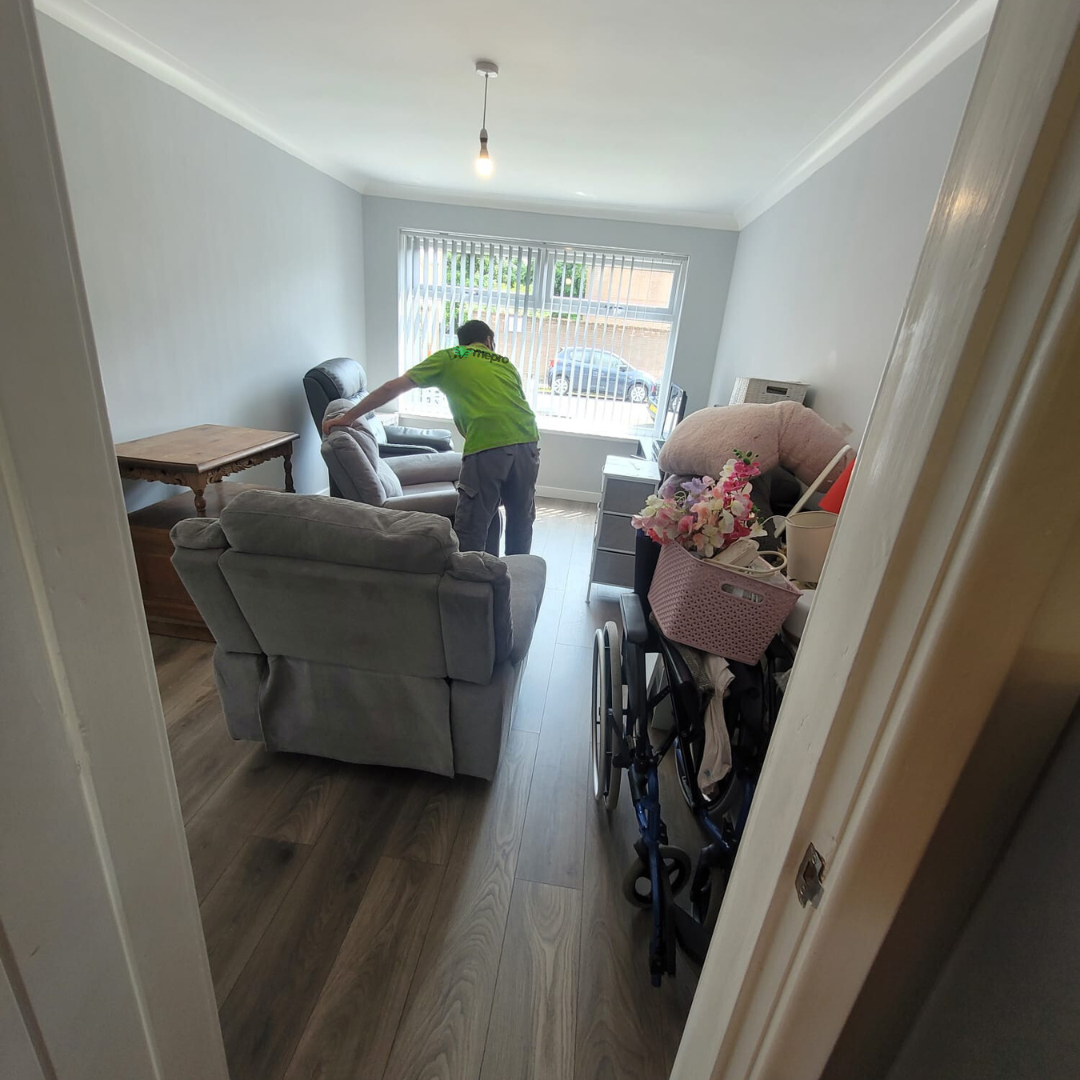 one A member of the Mepro Removals team skilfully manoeuvring an antique sideboard into a lift, showcasing expertise in specialist Downsizing Removals Manchester.
