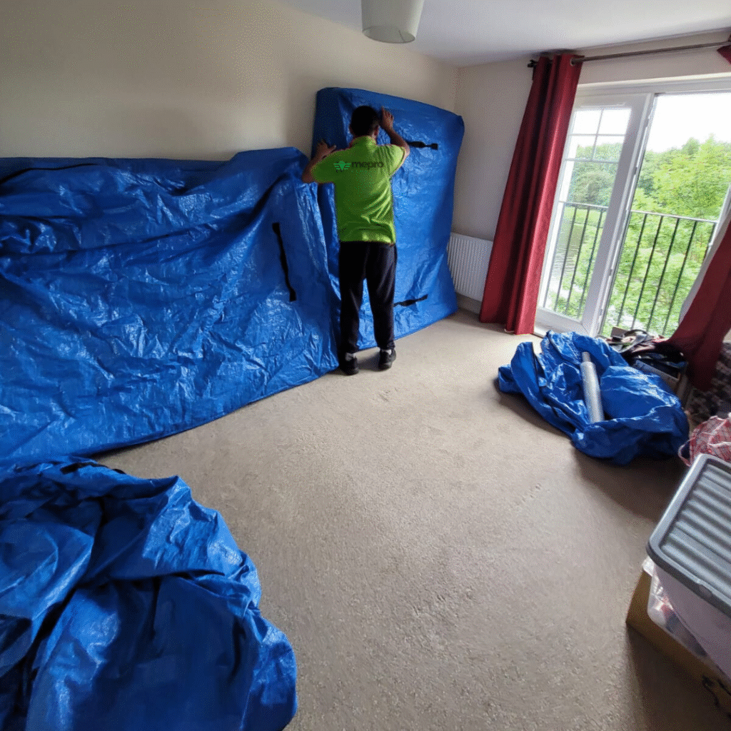 A member of the Mepro Removals team carefully packing a smart home hub, demonstrating the expert care taken by professional Manchester Smart Home Movers.