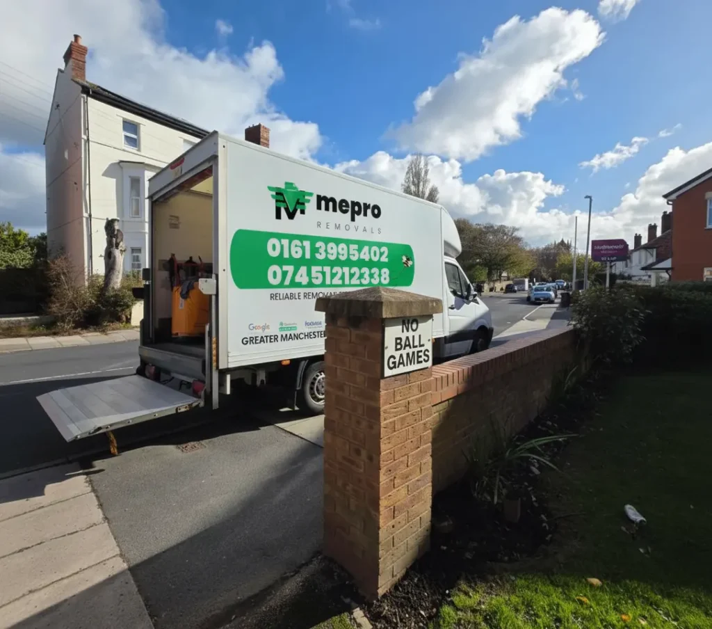 Mepro Removals team expertly maneuvering a heavy new appliance into a Manchester home during November.